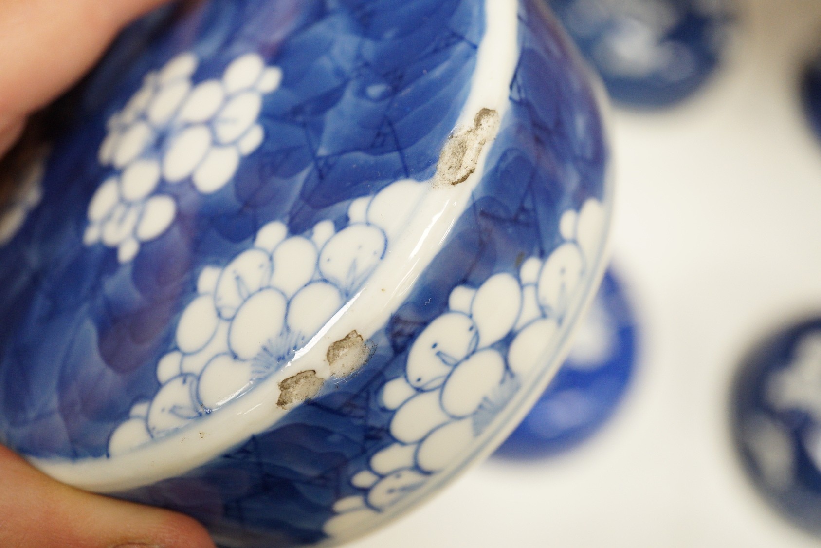 Twelve 18th/19th century Chinese blue and white ‘prunus’ vase and jar covers, largest 17 cm diameter, Provenance - D.C.Monk & Son, former dealers based in Kensington Church Street, London W8